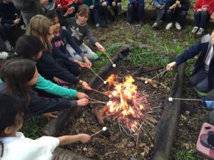 children toasting marshmallows on residential trip